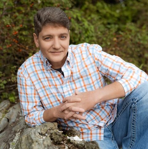 Norma leaning on a log